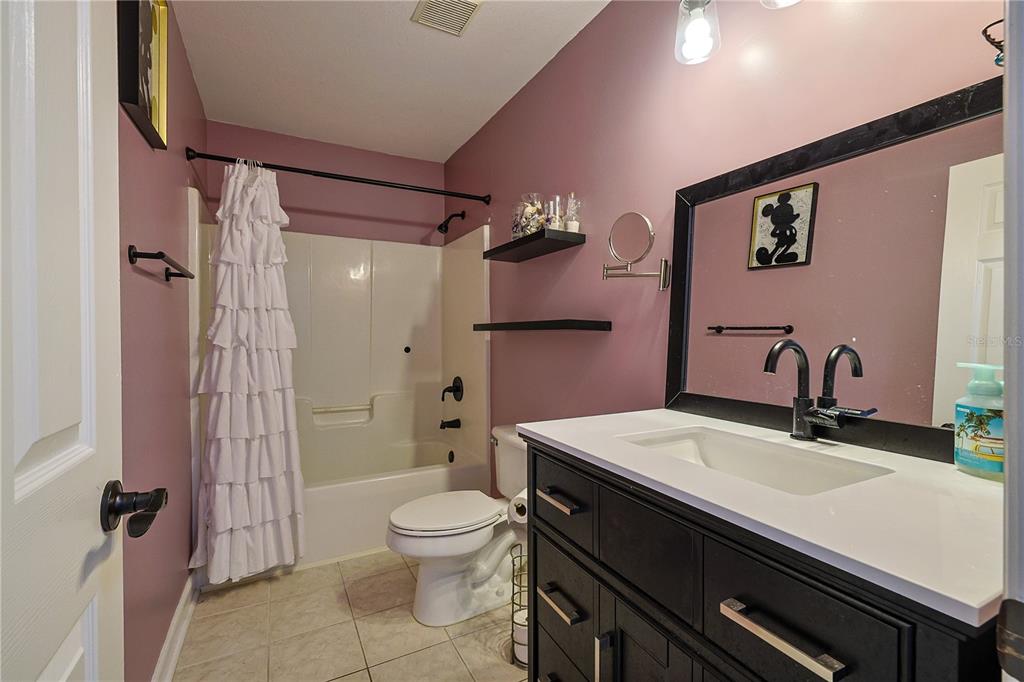 166 Southwest Hancock Court Lake City, FL 32024 - Photo 24 of 37 a bathroom with a sink a toilet a mirror and shower