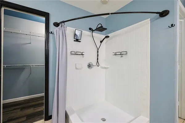 a bathroom with a glass shower door