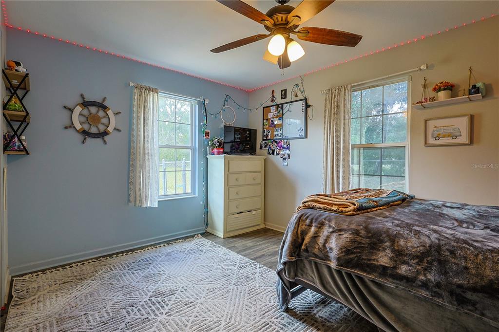 166 Southwest Hancock Court Lake City, FL 32024 - Photo 28 of 37 a bedroom with a bed and a chandelier