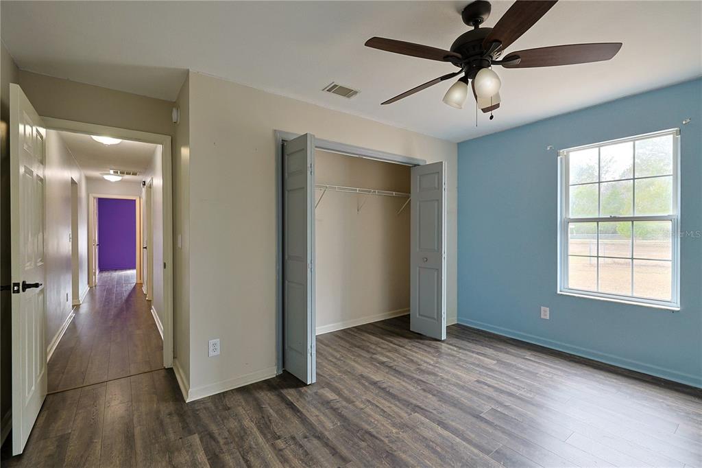 166 Southwest Hancock Court Lake City, FL 32024 - Photo 28 of 46 a view of empty room with wooden floor and fan