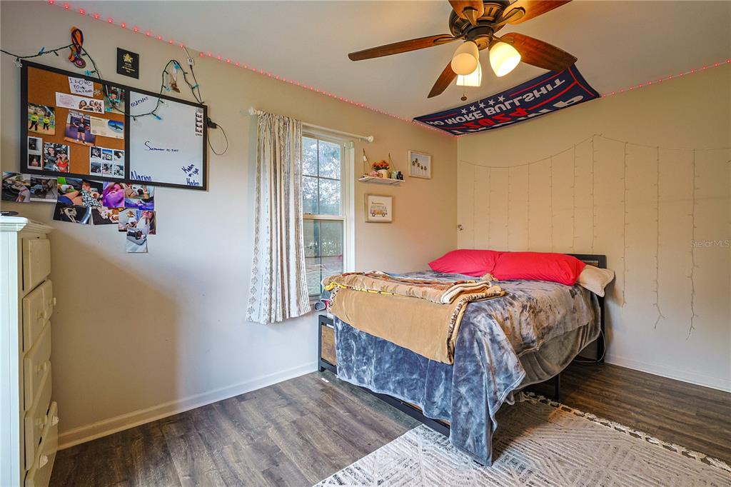 166 Southwest Hancock Court Lake City, FL 32024 - Photo 29 of 37 a bedroom with a bed and a chandelier