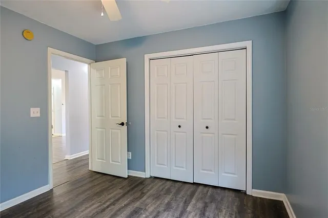 a view of empty room with wooden floor and entryway