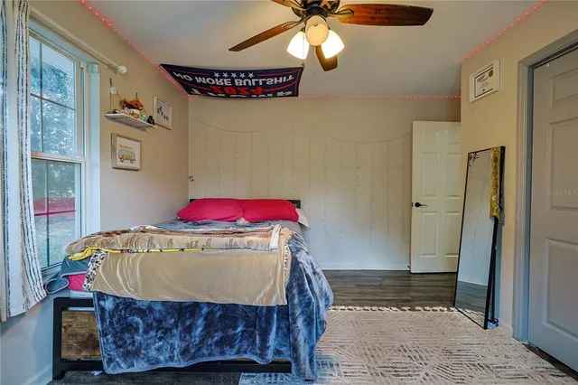 a bedroom with a bed and a chandelier