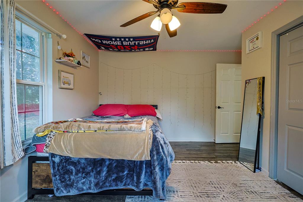 166 Southwest Hancock Court Lake City, FL 32024 - Photo 30 of 37 a bedroom with a bed and a chandelier