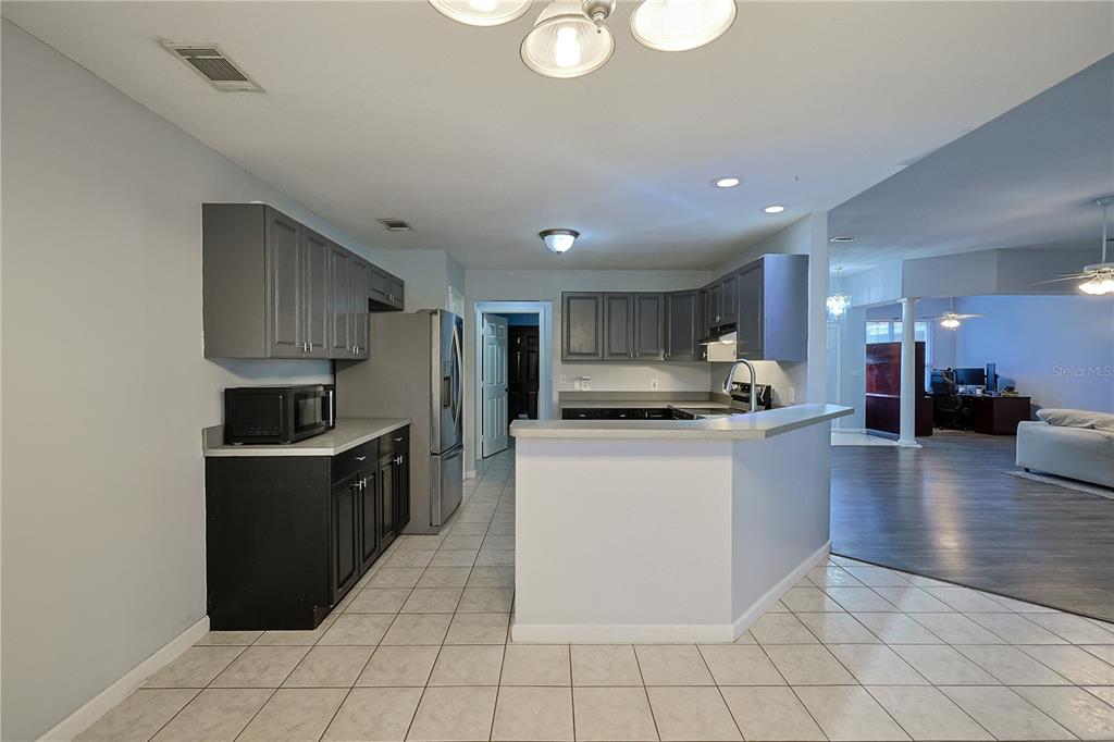 166 Southwest Hancock Court Lake City, FL 32024 - Photo 3 of 37 a kitchen with stainless steel appliances granite countertop a refrigerator and a stove top oven