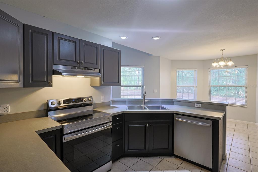 166 Southwest Hancock Court Lake City, FL 32024 - Photo 3 of 46 a kitchen with stainless steel appliances granite countertop a sink stove and cabinets