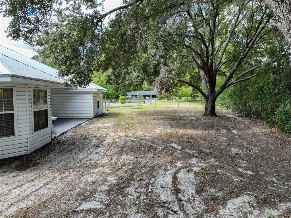 166 Southwest Hancock Court Lake City, FL 32024 - Photo 32 of 37 a view of a house with backyard and trees