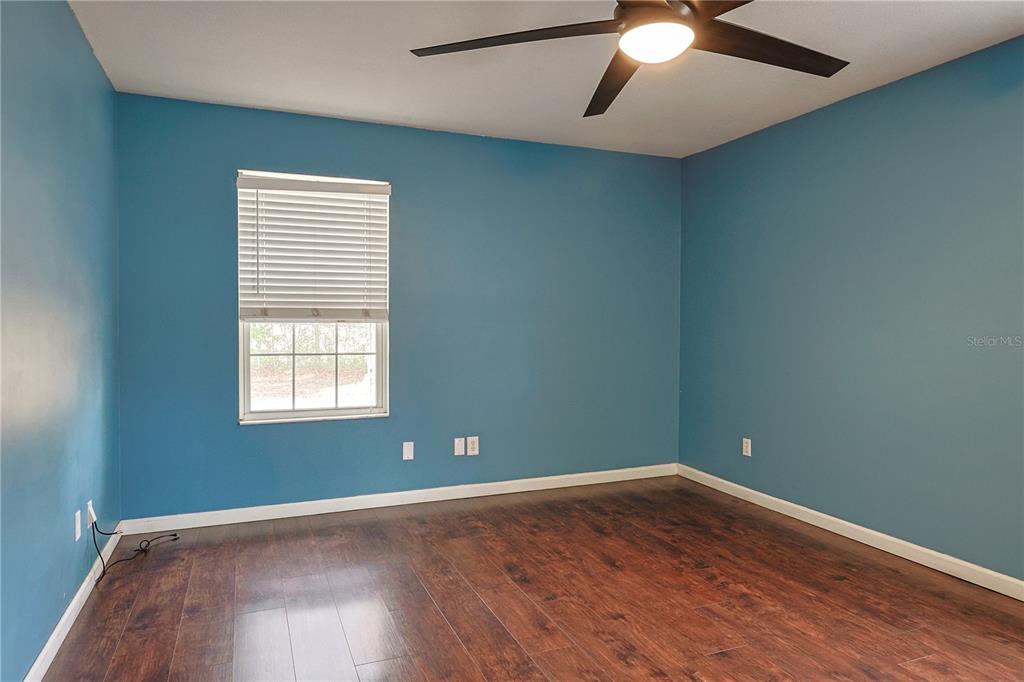 166 Southwest Hancock Court Lake City, FL 32024 - Photo 33 of 46 an empty room with wooden floor and windows