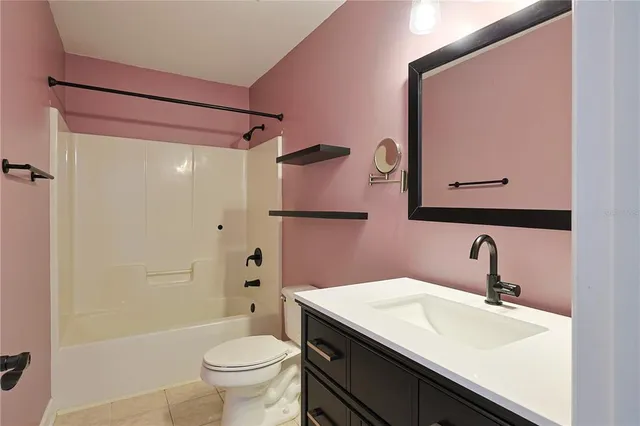 a bathroom with a sink a toilet and shower curtain