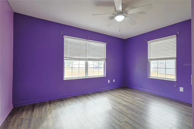 a view of an empty room window and wooden floor