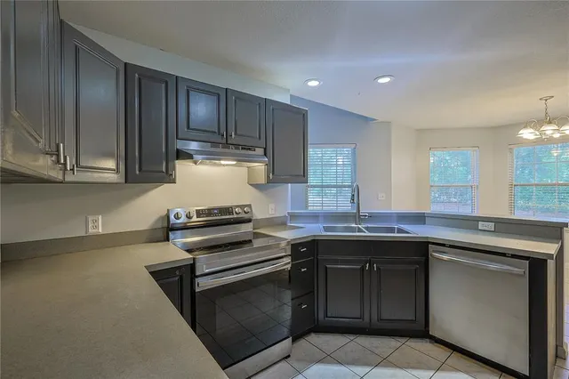 a kitchen with a sink stove and cabinets