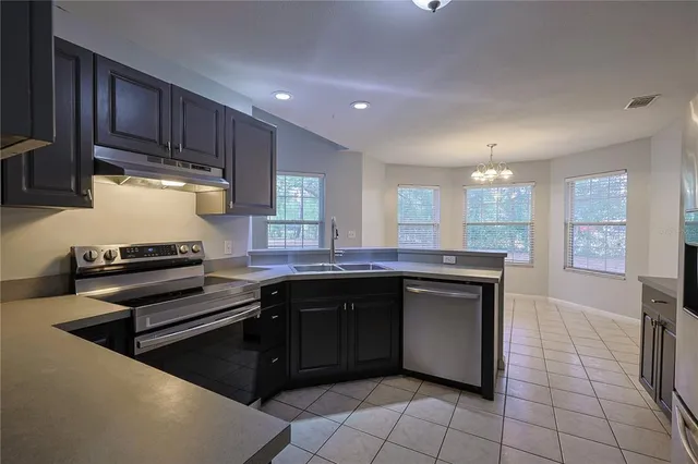 a kitchen with a sink and a stove