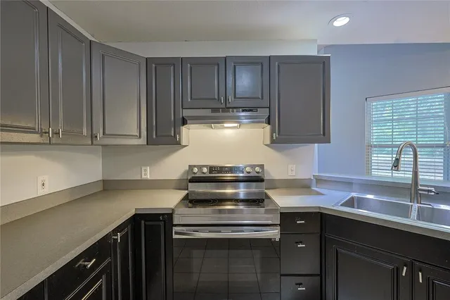 a kitchen with a stove and a sink