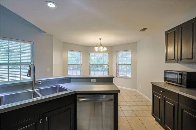 a kitchen with a sink and large window