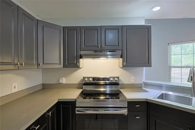 a kitchen with a stove and a sink