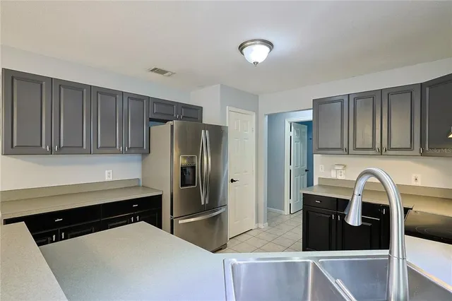 a kitchen with stainless steel appliances a refrigerator a stove and cabinets