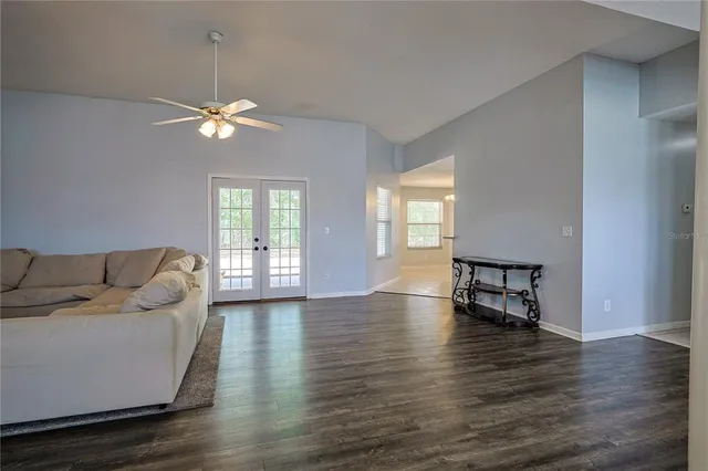 a living room with furniture wooden floor and a window