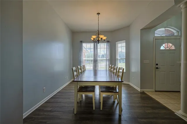 a view of a room with furniture wooden floor and chandelier