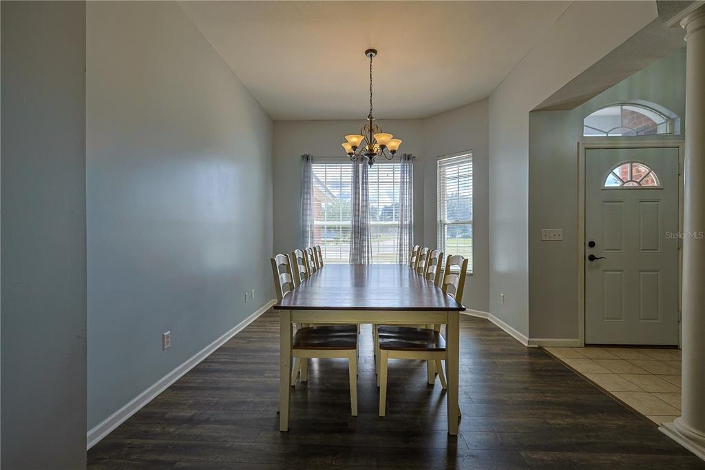 166 Southwest Hancock Court Lake City, FL 32024 - Photo 10 of 37 a view of a room with furniture wooden floor and chandelier