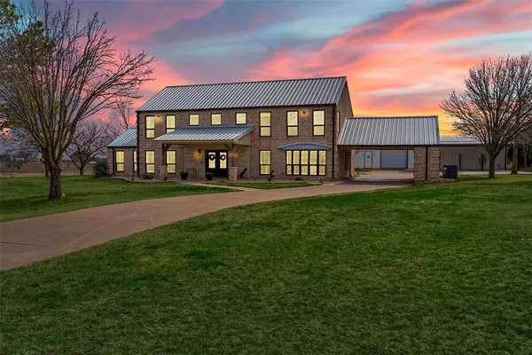 a front view of building with yard and green space