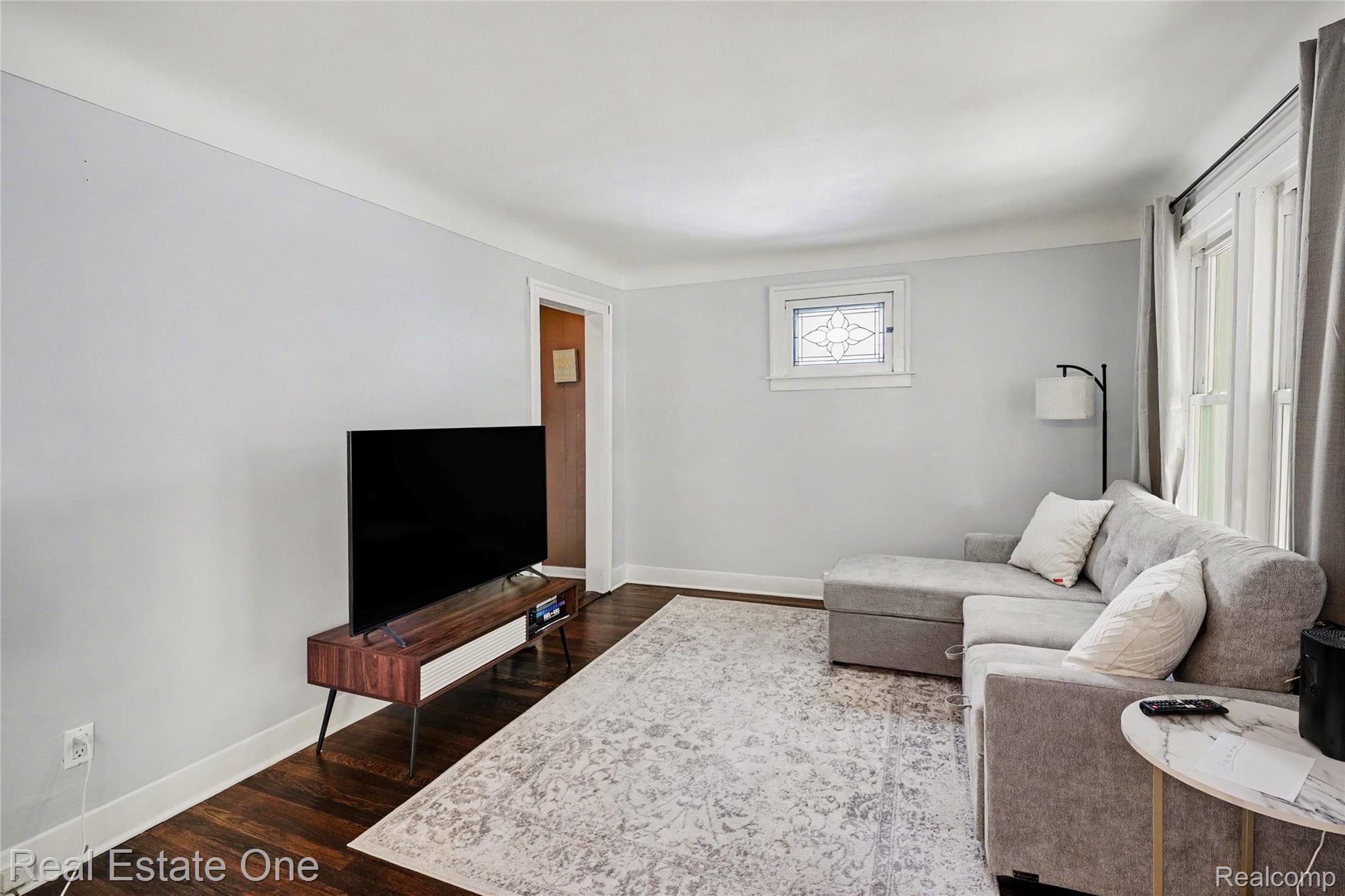 2073 Roslyn Road Grosse Pointe, MI 48236 - Photo 6 of 30 Living area featuring dark wood-finish flooring, light grey walls, and white trim