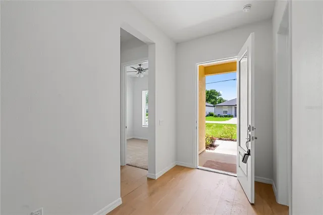 a view of entryway and hall with wooden floor