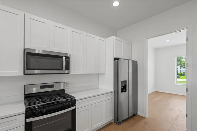 a view of a kitchen with a dishwasher and a chandelier