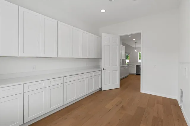 a bathroom with a granite countertop sink toilet a mirror and shower
