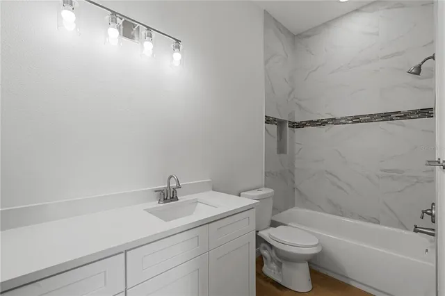 a kitchen with granite countertop a sink and a stove top oven