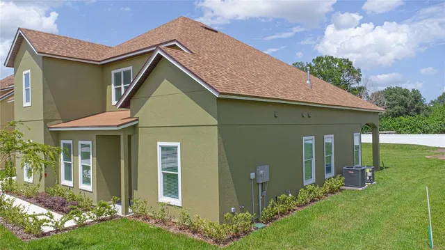 a large house with a big yard and large trees
