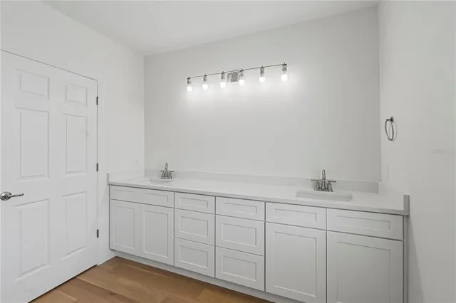 an aerial view of residential houses with outdoor space and trees