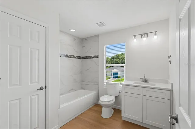 an aerial view of residential houses with outdoor space and street view