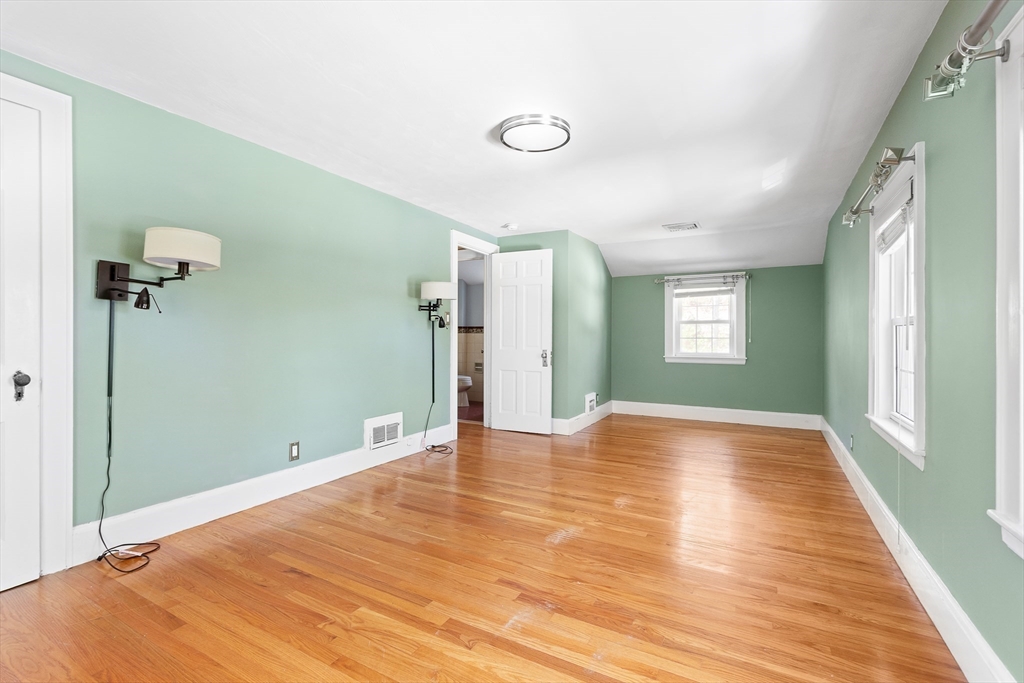 587 Greendale Avenue Needham, MA 02492 - Photo 16 of 36 a view of empty room with wooden floor and fan