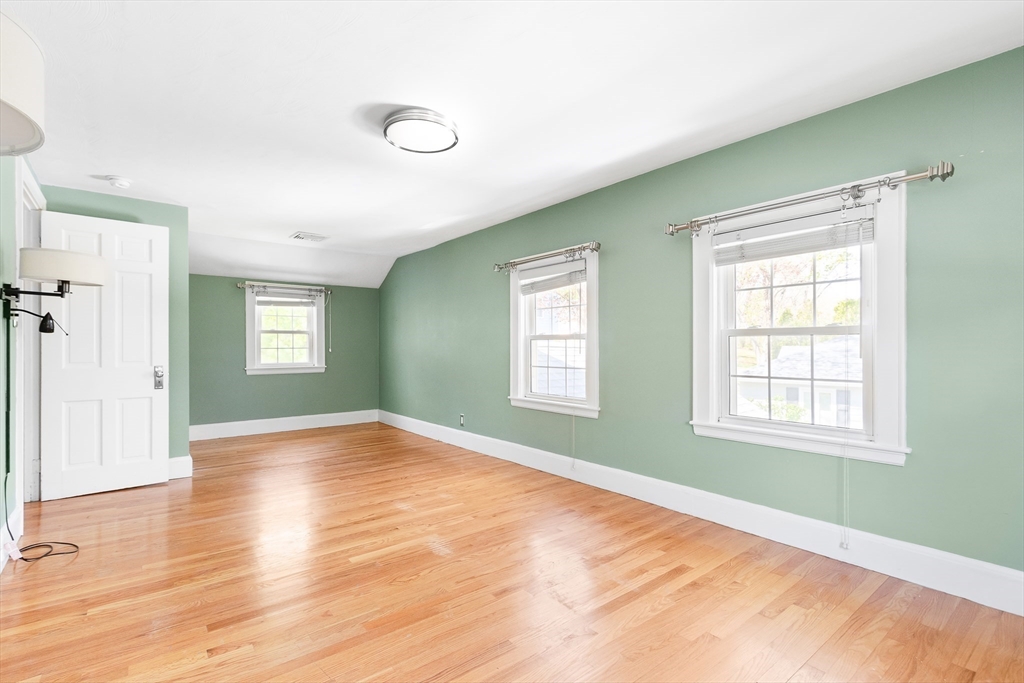 587 Greendale Avenue Needham, MA 02492 - Photo 18 of 36 a view of an empty room with wooden floor and a window