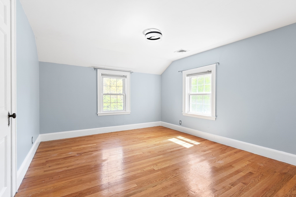 587 Greendale Avenue Needham, MA 02492 - Photo 20 of 36 a view of an empty room with wooden floor and a window