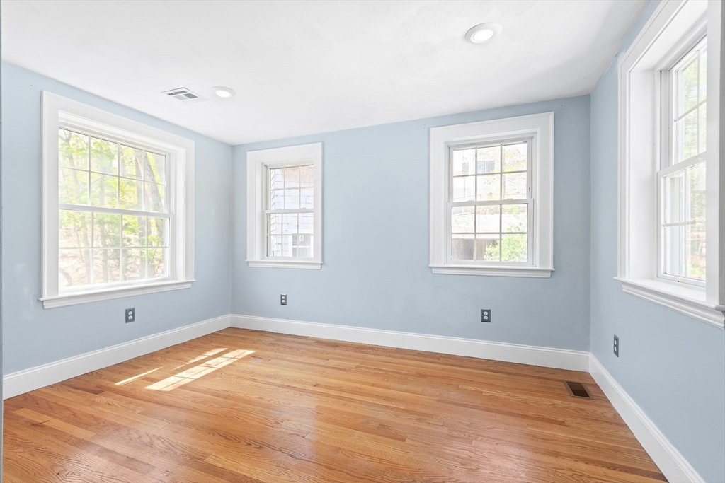 587 Greendale Avenue Needham, MA 02492 - Photo 21 of 36 a view of a room with wooden floor and windows in it
