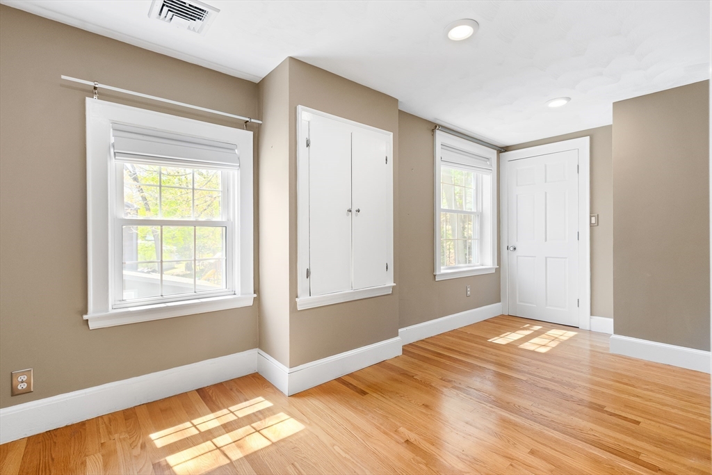 587 Greendale Avenue Needham, MA 02492 - Photo 24 of 36 a view of an empty room with wooden floor and a window