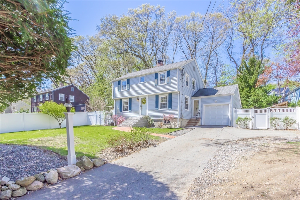 587 Greendale Avenue Needham, MA 02492 - Photo 34 of 36 a front view of a house with a yard table and chairs