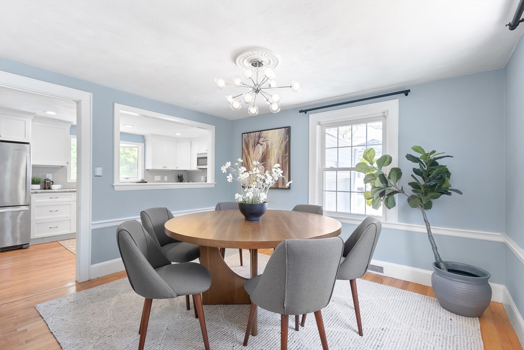 587 Greendale Avenue Needham, MA 02492 - Photo 5 of 36 a dining room with furniture potted plants and wooden floor
