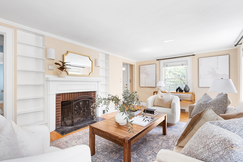 587 Greendale Avenue Needham, MA 02492 - Photo 7 of 36 a living room with furniture a window and a fireplace
