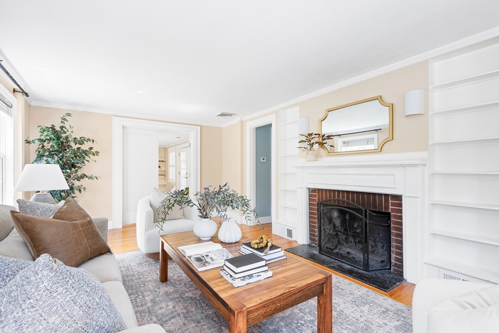 587 Greendale Avenue Needham, MA 02492 - Photo 8 of 36 a living room with furniture and a fireplace