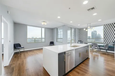 a large white kitchen with a large window