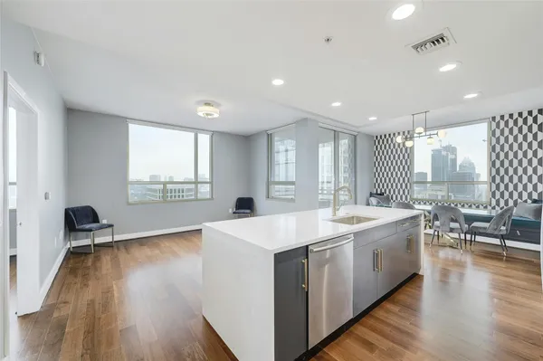 a large white kitchen with a large window