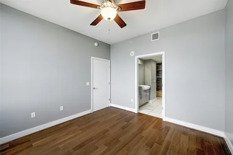 a view of an empty room and window and wooden floor