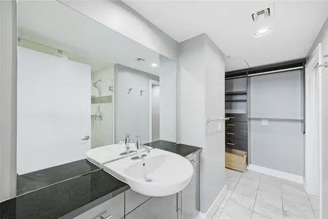 a spacious bathroom with a sink and a large mirror