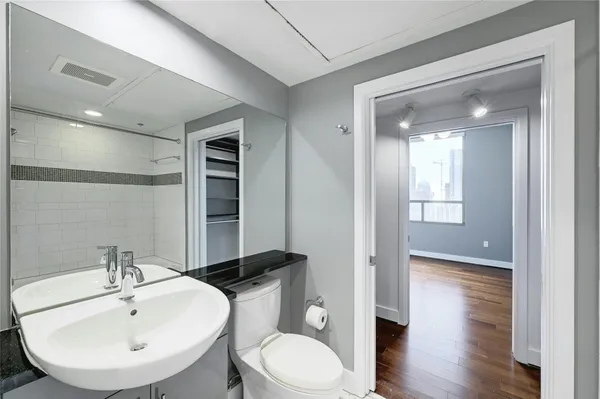 a bathroom with a toilet sink and mirror