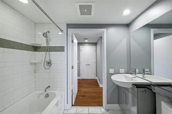 a bathroom with a sink a mirror and a bathtub