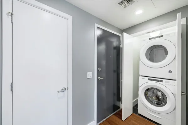 a view of a hallway with washer and dryer