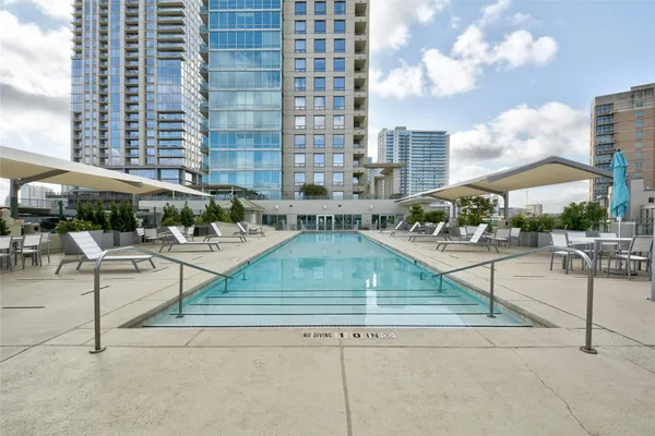 a view of yard with swimming pool and sitting area