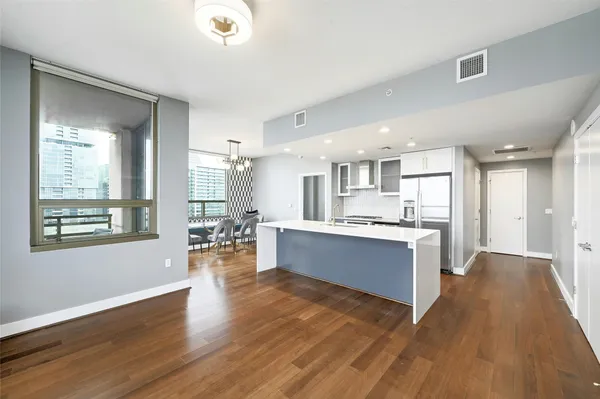 a view of large kitchen with wooden floor and windows
